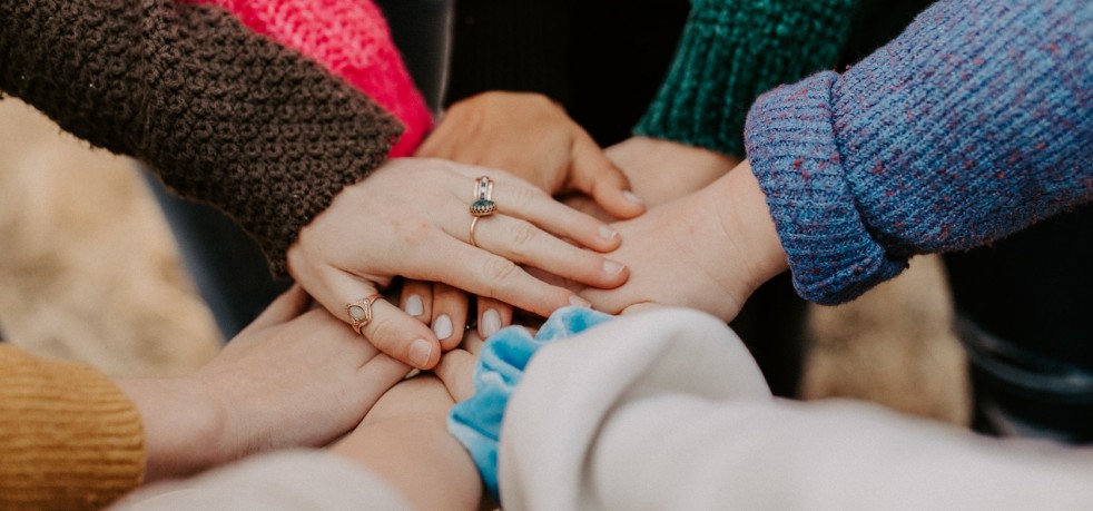 A group of people touching hands