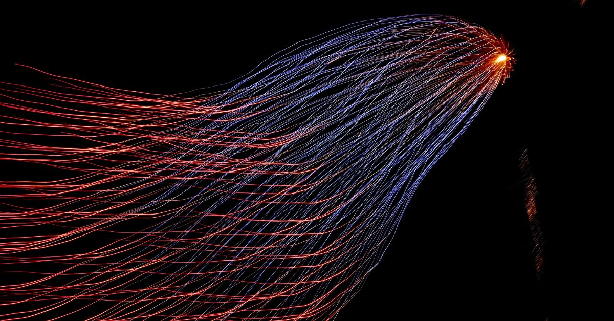 Trail of light spreading diagonally, red at the bottom left turning into blue on the top left 